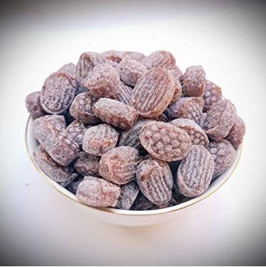 Bowl of sugared almonds on a white background