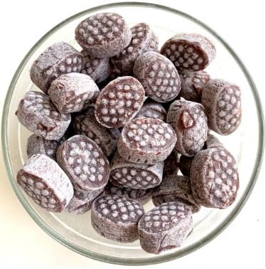 Glass bowl filled with chocolate-dipped ladyfinger cookies on a white background