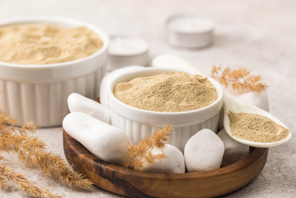 Bowls of powder on a neutral background with decorative elements